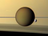 Titan and Dione Silhoutted by Saturn
