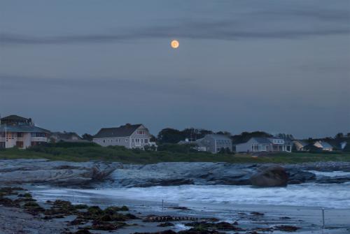 The Full Moon rises over Ocean Avenue in Newport, RI. Image credit: Scott MacNeill