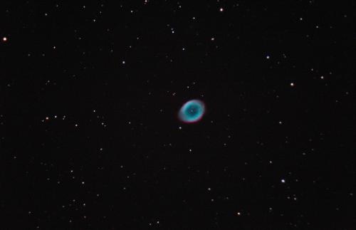 The Ring Nebula is found in the constellation Lyra and is the demise of a sun-like star. Residing at a distance of 2,300 light years, the expanding shell of ionized gas around the exposed stellar core covers an diameter of about 2.6 light years. This star is transitioning into a compact white dwarf. The exposed stellar core is no longer undergoing fusion. Intense ultraviolet light emit from the hot stellar core ionizes its own shell. Image Credit: Scott MacNeill, Frosty Drew Observatory