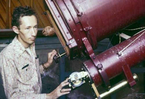 Robert Burnham Jr with the telescope that Clyde Tombaugh used to discover Pluto.