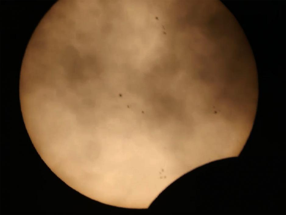 Clouds, Sunspots, and a Solar Eclipse